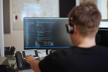 real male web programmer coding javascript, php, symfony, react at work