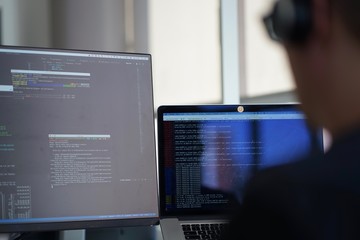Real male web programmer coding javascript, php, symfony, react at work 