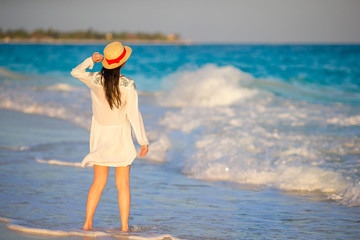 Woman laying on the beach enjoying summer holidays looking at the sea