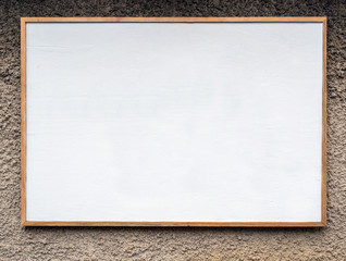 Wall Mural - Empty wood frame mounted on outdoor stone wall.