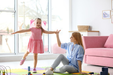 Poster - Mother playing with her child at home