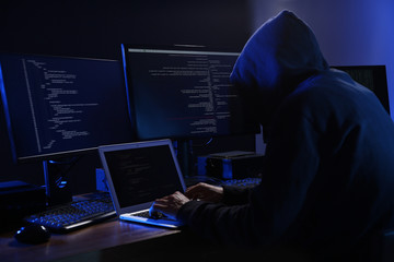 Hacker with computers in dark room. Cyber crime