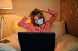 © ZaStock - Young businesswoman in a medical protective mask works from home at the computer during self-isolation and quarantine. Virus coronavirus outbreak, flu epidemic and covid ncov novel. Stay home.