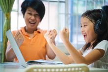 Asian Girl And Her Teacher Using Laptop For Online Study During Homeschooling At Home. Homeschooling, Online Study, Home Quarantine, Online Learning, Corona Virus Or Education Technology Concept