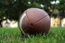 American Football Ball On The Grass In A Spanish Town