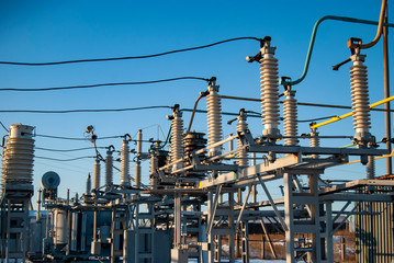 High voltage transformer substation in winter. High voltage power lines. Power transmission technology.