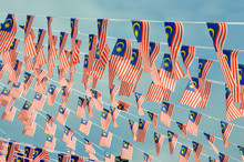 Selective Focused On Small Size Malaysian Flags Tied Together In Large Quantities. Fluttering In The Wind.