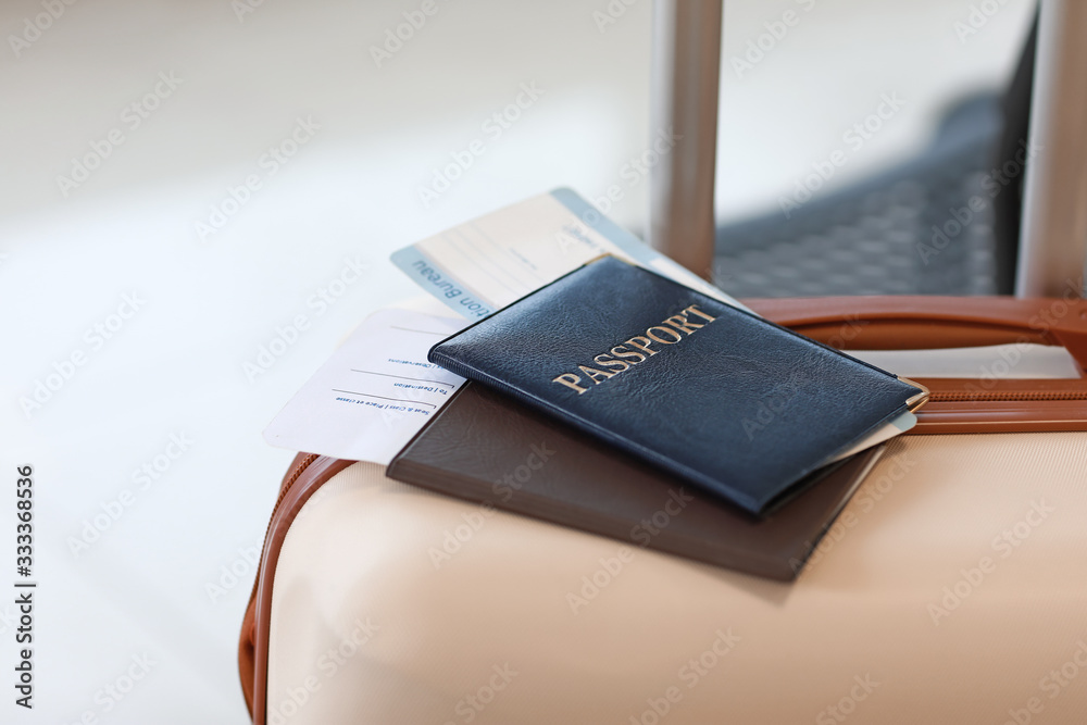 Passports and packed suitcase at the airport, closeup