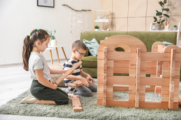 Wall Mural - Little children playing with take-apart house at home