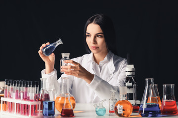 Wall Mural - Female alchemist with potions at table