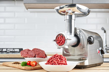 Bowl Of Mince With Electric Meat Grinder In Kitchen Interior