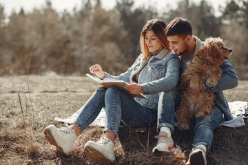 Woman in a jeans clothes. Couple in a spring forest. People with a cute dog.