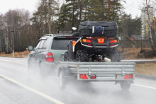 Quad Bike Transportation, A 4x4 Car With A Trailer On The Suburban Highway