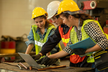 Poster - Mechanic working group in factory,Technician wearing safety harness work together as team use laptop maintenance and check the machine working in factory.