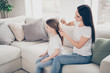 © deagreez - Profile side photo of positive loving happy family mother comb hair her little kid daughter prepare for primary school day sit divan in house indoors
