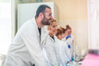© Vladimir Borovic - Group of  young scientist in laboratory working and learning