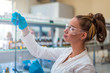 © Vladimir Borovic - Beautiful young woman scientist in laboratory working. Young female scientist doing some research.