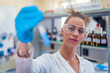 © Vladimir Borovic - Beautiful young woman scientist in laboratory working. Young female scientist doing some research.