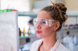 © Vladimir Borovic - Beautiful young woman scientist in laboratory working. Young female scientist doing some research.