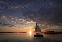 Sunset On The Sea And A Sail Boat