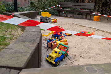 Corona crisis - Children's playground cordoned off with a red and white barrier tape in the courtyard of a residential building in Berlin-Prenzlauer Berg. So the contact ban should be enforced.