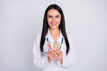 Canvas Print - Photo of beautiful professional cheerful doc lady proposing several variants pills vitamin c tablets recommend take wear stethoscope white lab coat isolated grey color background