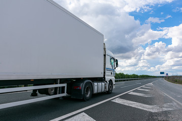 Wall Mural - Truck with refrigerated semi-trailer for the transport of perishable food circulating on the highway