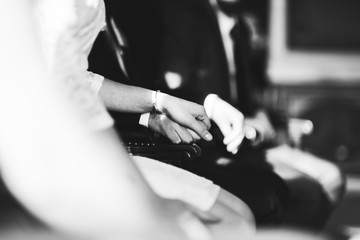 Poster - wedding couples hands holding at the cerenomy, sitting inside registry office