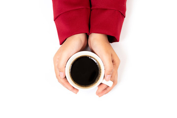 Woman hands hold a white cup of coffee, top view