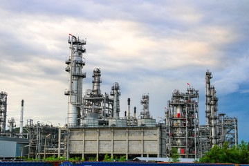 petrochemical​ plant and refinery​ factory, oil​ and​ gas​ industrial​ at​ blue​ cloud​ sky​ sunrise​ background​