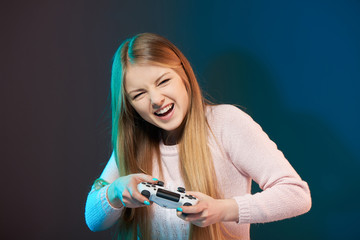 Wall Mural - Excited woman playing video game with joystick