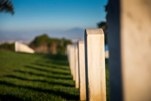 Headstones Cast Afternoon Shadows On The Green Grass, As The Sun Sets Over Fort Rosecrans National Cemetery In Point Loma, San Diego, California.