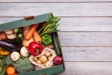 Fresh Organic Vegetable Delivery Box On A Wooden Background