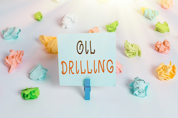 Poster - Text sign showing Oil Drilling. Business photo showcasing involves the drilling and pumping of oil from underground wells Colored crumpled papers empty reminder white floor background clothespin
