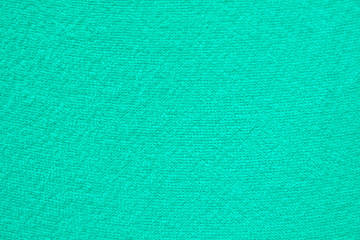 a simple example of a texture of soft, fleecy fabric, a green background.