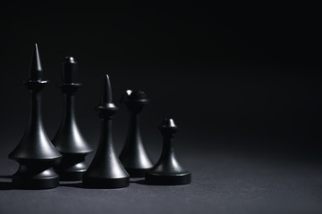 Wall Mural - dark chess figures on black with copy space