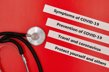 Wall Mural - Concept of COVID-19. Coronavirus disease. Stethoscope with inscriptions about COVID-19 on the red background. Healthcare and medical concept.