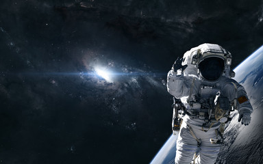 Wall Mural - astronaut on the background of a bright star in the center of the galaxy. deep space planet. science