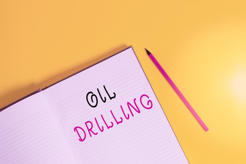 Poster - Text sign showing Oil Drilling. Business photo text involves the drilling and pumping of oil from underground wells Open striped hard cover notebook lying pencil marker color background
