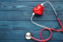 Stethoscope With Red Heart On Blue Wooden Table
