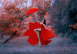 © kharchenkoirina - Beautiful elegant happy woman fly with umbrella. Red long sexy silk dress fabric fluttering in wind. goddess dancing joyful cheerful in air. Mystic autumn trees forest. Art fantasy levitation princess