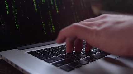 4k close-up hacker hands typing on a laptop,The Matrix style binary code on laptop,falling number,data digital display,future tech concept background.