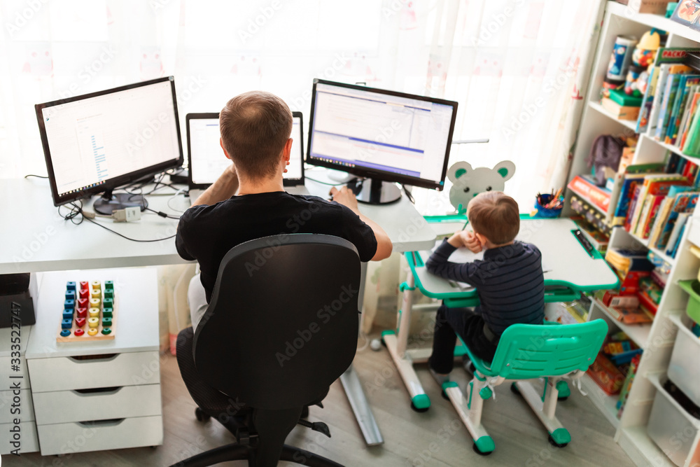 Father with kid working from home during quarantine. Stay at home, work from home concept during coronavirus pandemic - obrazy, fototapety, plakaty 