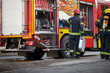 © luckybusiness - Fireman in uniform in front of fire truck going to rescue and protect. Emergancy servise concept.