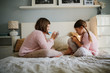 © natalialeb - caucasian girls children play games paper at home