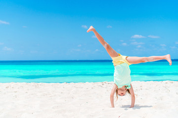 Adorable little girl have fun at tropical beach during vacation