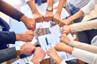 © Krakenimages.com - Group of business workers standing bumping fists at the office