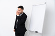 © luismolinero - Young man giving a presentation on white board and whispering something