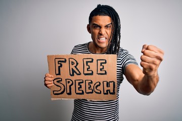 Wall Mural - Young african american man with dreadlocks holding banner with free speech message protest annoyed and frustrated shouting with anger, crazy and yelling with raised hand, anger concept