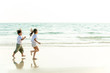 © CandyRetriever  - Happy little Asian brother and sister running and playing with smiling and laughing together on the beach at sunset. Adorable kids girl and boy relax and having fun in summer holiday vacation travel.